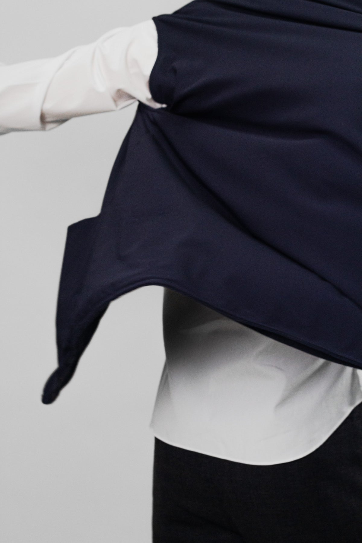 The reversible vest lifted to show the shirt beneath